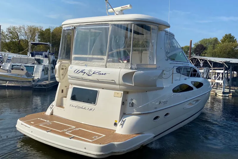 Slide: The Image of 2004 Cruisers Yachts 455 Express Motoryacht docked in a marina. - 3