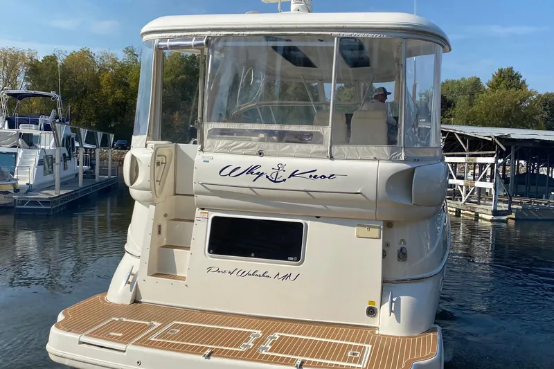 Slide: The Image of 2004 Cruisers Yachts 455 Express Motoryacht docked at marina, rear view. - 5