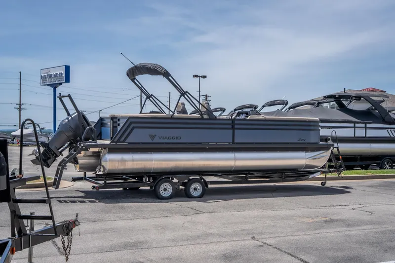 Slide: The Image of 2026 Viaggio X24U pontoon boat on trailer at dealership parking lot. - 10