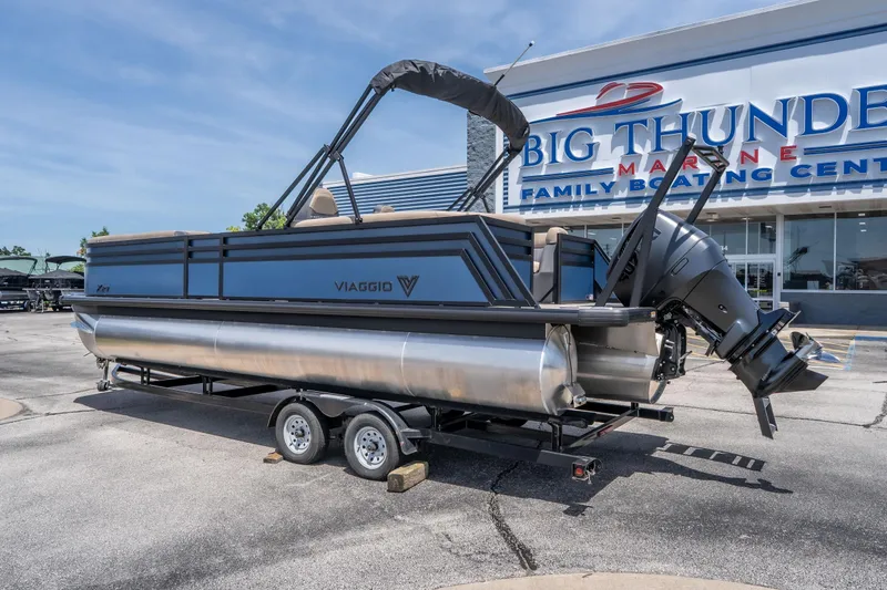 Slide: The Image of 2026 Viaggio X24U pontoon boat on trailer at Big Thunder Marine dealership. - 13