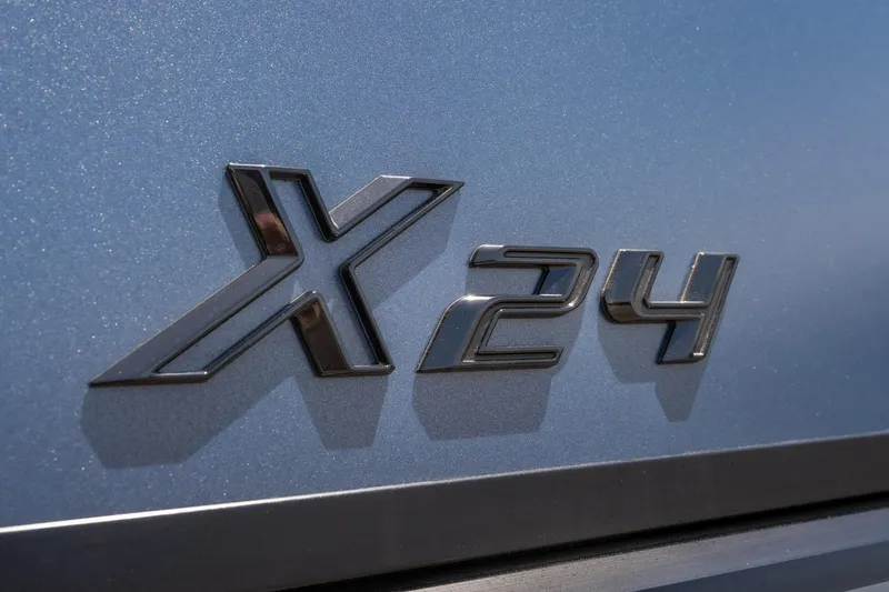 Slide: The Image of Viaggio X24U 2026 model emblem on metallic blue surface. - 15