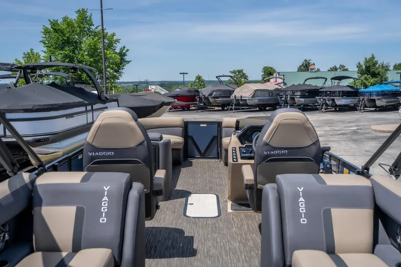 Slide: The Image of 2026 Viaggio X24U boat interior with sleek seating and modern design at a marina. - 22