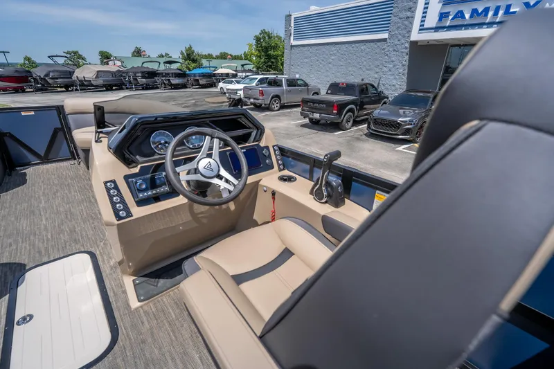 Slide: The Image of Interior of 2026 Viaggio X24U boat with modern steering and controls at dealership. - 24