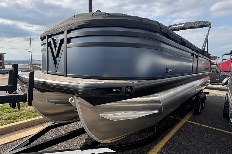 Slide: The Image of 2026 Viaggio X24U pontoon boat with sleek design and modern features, parked on a trailer. - 3