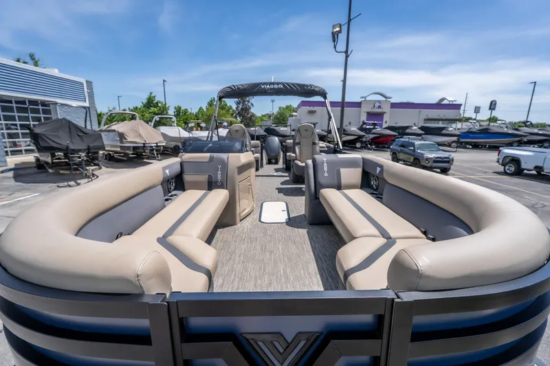 Slide: The Image of 2026 Viaggio X24U pontoon boat with spacious seating in a dealership lot. - 36