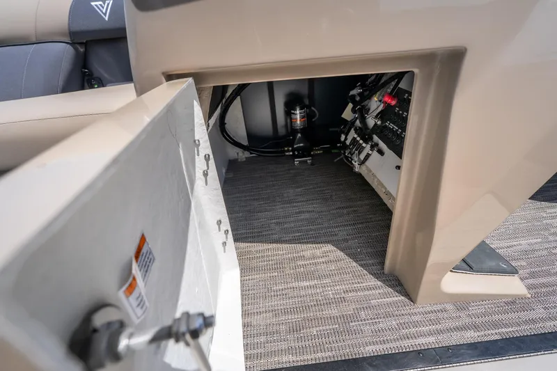 Slide: The Image of Interior view of a 2026 Viaggio X24U boat, showcasing storage and control panel. - 38