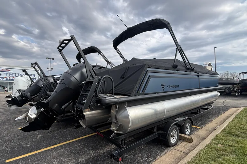 Slide: The Image of 2026 Viaggio X24U pontoon boat with dual outboard motors on a trailer. - 7