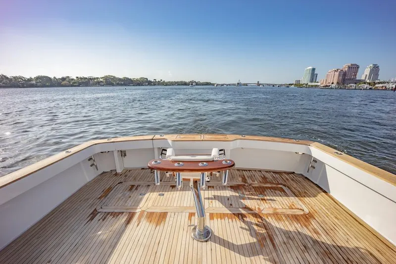 Slide: The Image of 2003 Viking 65 EB yacht deck overlooking calm waters and distant city skyline. - 10