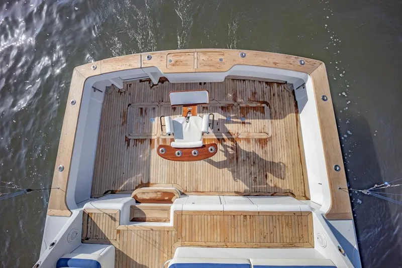 Slide: The Image of Aerial view of 2003 Viking 65 EB yacht's wooden deck and seating area. - 11