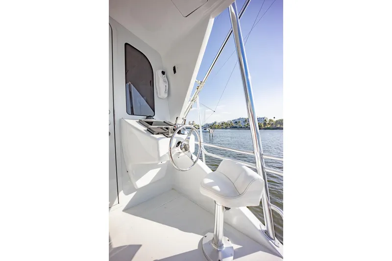 Slide: The Image of Helm station of 2003 Viking 65 EB yacht with steering wheel and chair. - 14