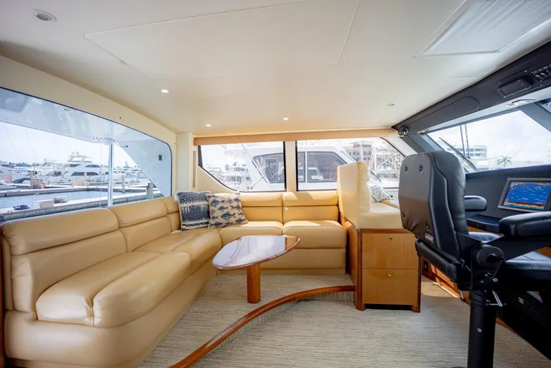 Slide: The Image of Luxurious interior of 2003 Viking 65 EB yacht with leather seating and modern helm. - 17