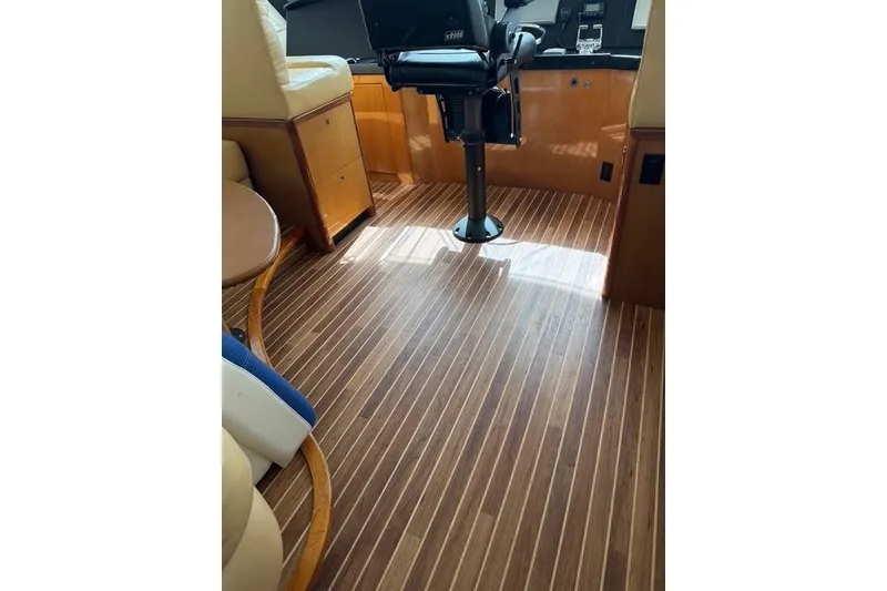 Slide: The Image of Interior of 2003 Viking 65 EB yacht with polished wood flooring and seating. - 19