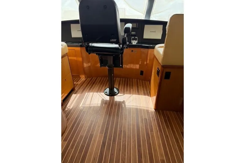 Slide: The Image of Pilot chair and dashboard inside a 2003 Viking 65 EB yacht cockpit. - 22