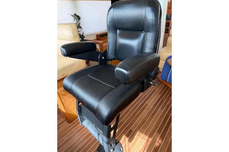 Slide: The Image of Luxurious black leather captain's chair on a 2003 Viking 65 EB yacht. - 24