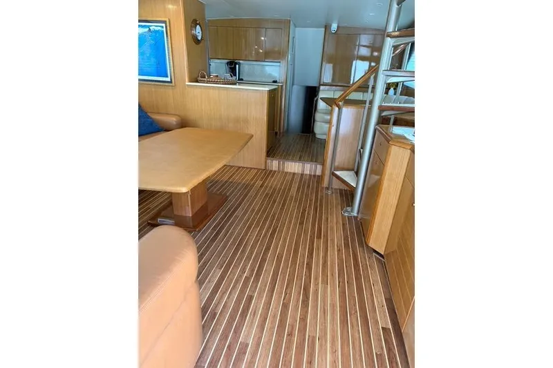 Slide: The Image of Luxurious interior of 2003 Viking 65 EB yacht with wooden flooring and modern furnishings. - 25