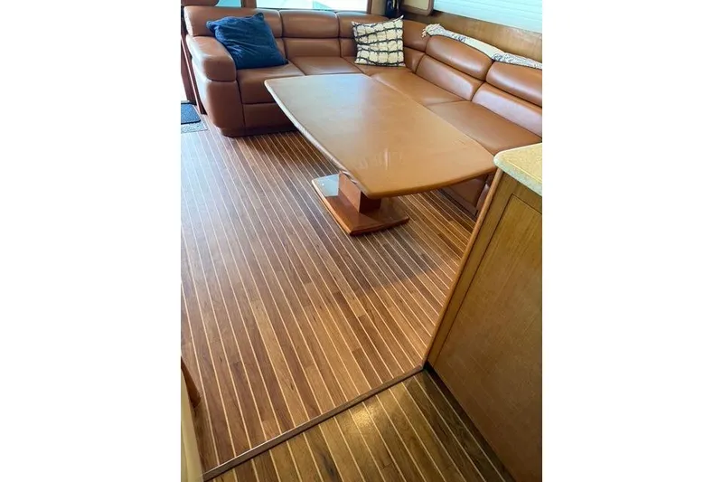 Slide: The Image of Luxurious interior of 2003 Viking 65 EB yacht with leather seating and wooden flooring. - 28