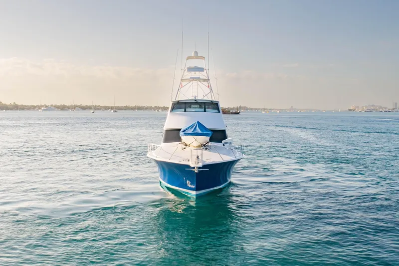 Slide: The Image of Front view of a 2003 Viking 65 EB yacht cruising on calm waters. - 3