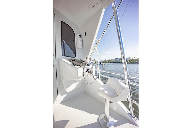 Slide: The Image of Helm station of 2003 Viking 65 EB yacht with steering wheel and chair. - 33