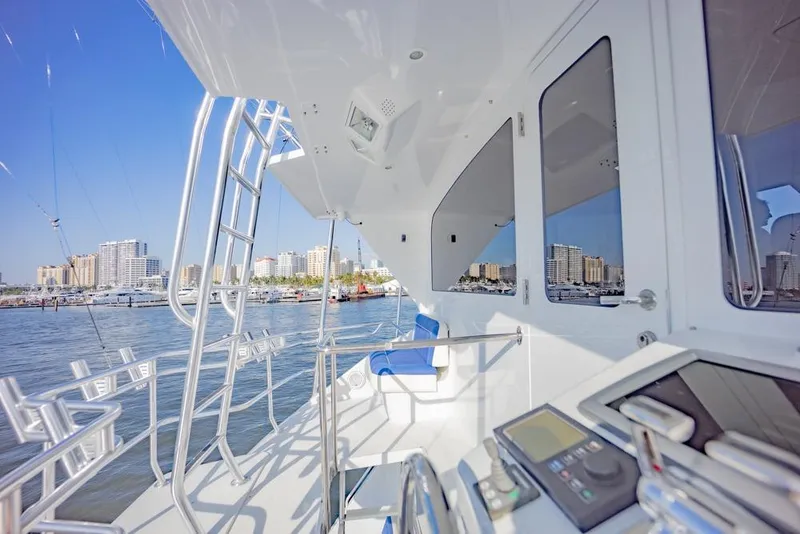 Slide: The Image of 2003 Viking 65 EB yacht deck with city skyline in the background. - 34