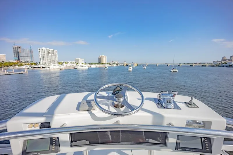 Slide: The Image of Helm view from 2003 Viking 65 EB yacht overlooking marina and cityscape. - 35