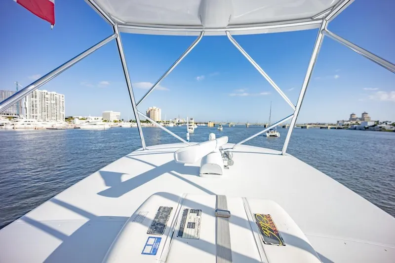 Slide: The Image of 2003 Viking 65 EB yacht bridge view with cityscape and marina in the background. - 37
