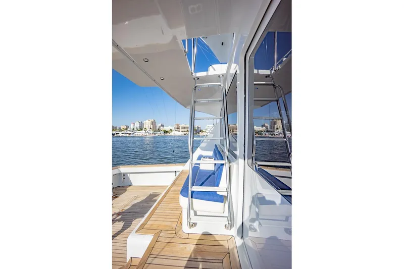 Slide: The Image of 2003 Viking 65 EB yacht deck with blue seating, overlooking a marina. - 39