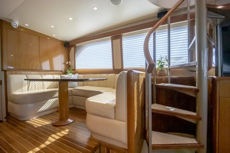 Slide: The Image of Luxurious interior of 2003 Viking 65 EB yacht with elegant seating and spiral staircase. - 44