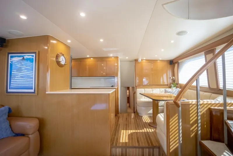 Slide: The Image of Luxurious interior of 2003 Viking 65 EB yacht with elegant wood finishes and cozy seating. - 45