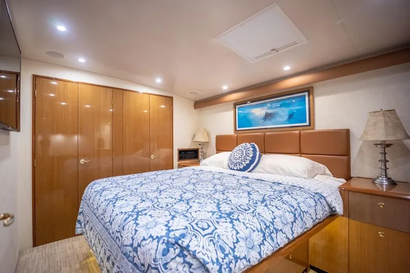 Slide: The Image of Luxurious bedroom interior of 2003 Viking 65 EB yacht with elegant decor and lighting. - 47