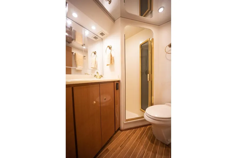 Slide: The Image of Luxurious bathroom in 2003 Viking 65 EB yacht with wood cabinetry and enclosed shower. - 49