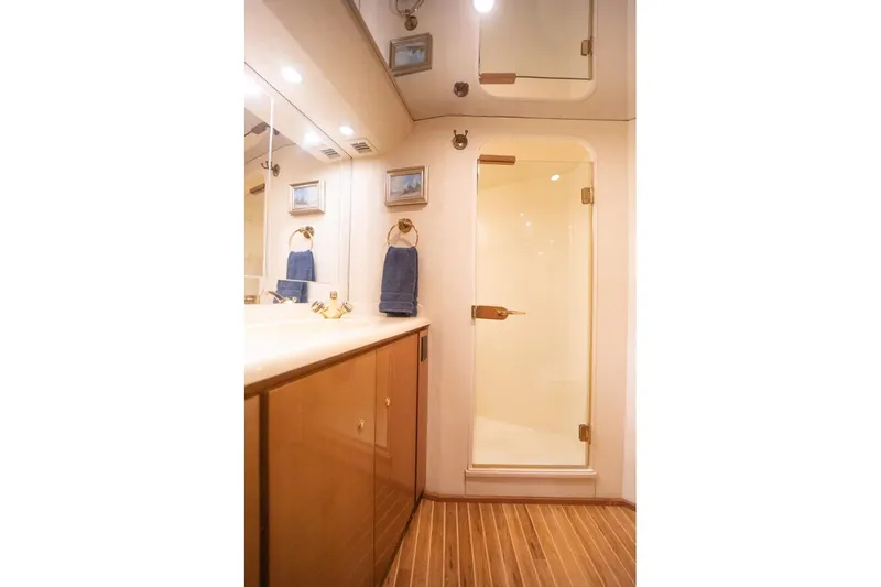 Slide: The Image of Luxurious bathroom in 2003 Viking 65 EB yacht with wooden flooring and glass shower door. - 51