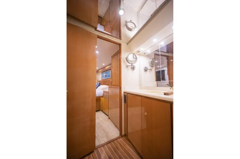 Slide: The Image of Luxurious bathroom interior of 2003 Viking 65 EB yacht with wooden cabinetry and mirrors. - 52