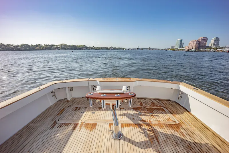 Slide: The Image of 2003 Viking 65 EB yacht deck overlooking calm waters and city skyline. - 7