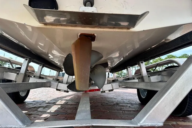 Slide: The Image of Underneath view of a 2012 Tigé R20 boat on a trailer, showcasing the propeller. - 12