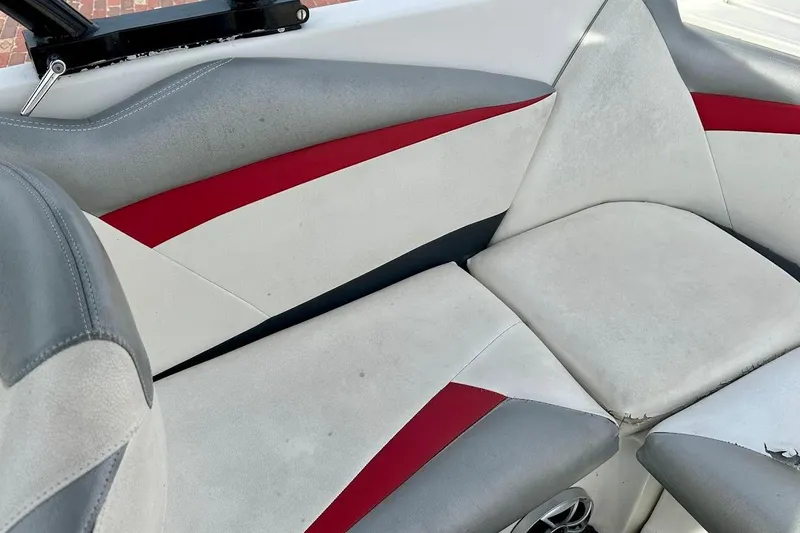 Slide: The Image of 2012 Tigé R20 boat interior with gray, red, and white upholstery. - 18