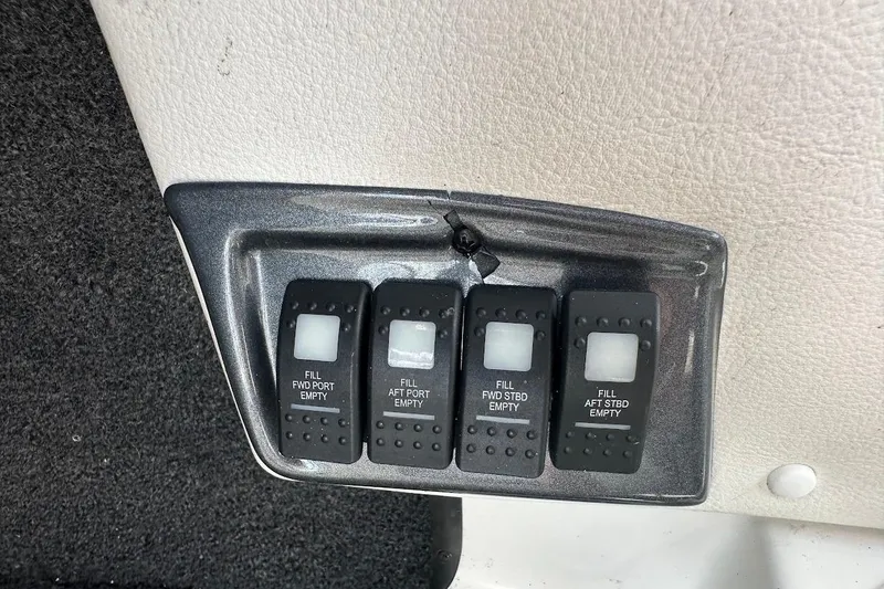 Slide: The Image of Control panel with ballast switches on a 2012 Tigé R20 boat. - 22