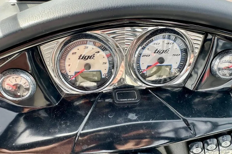 Slide: The Image of Dashboard of a 2012 Tigé R20 boat with speedometer and tachometer. - 25