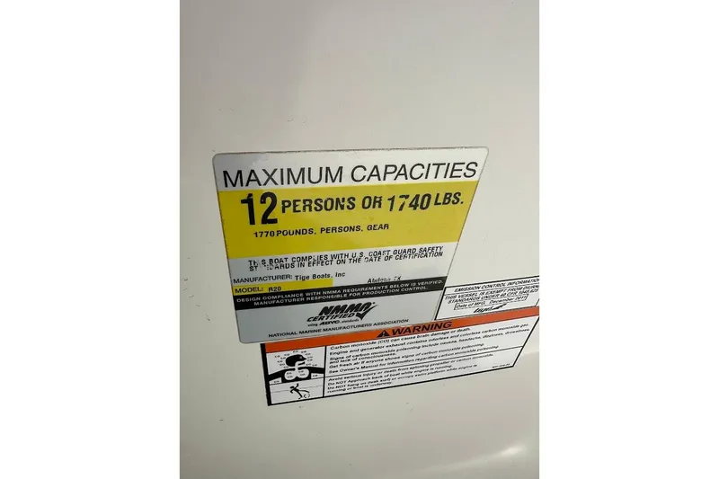 Slide: The Image of 2012 Tigé R20 capacity label, maximum 12 persons or 1,740 lbs, safety compliance details. - 27