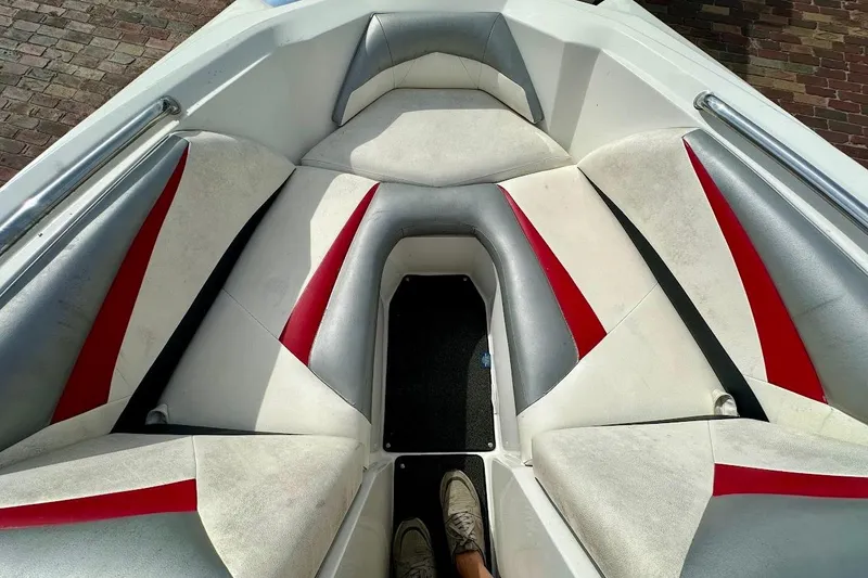 Slide: The Image of Interior of a 2012 Tigé R20 boat with red and gray seating. - 30