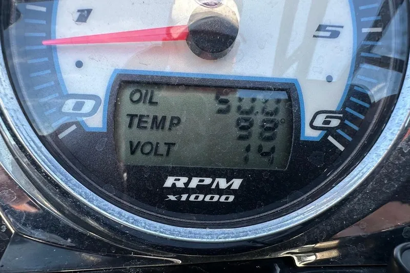 Slide: The Image of Close-up of a 2012 Tigé R20 boat gauge displaying oil, temperature, and voltage readings. - 32