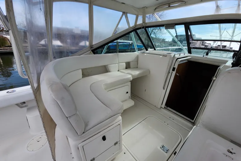 Slide: The Image of Interior of 2000 Tiara Yachts 3100 Open, featuring white seating and helm area. - 10