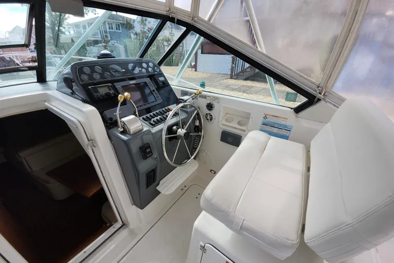 Slide: The Image of Cockpit of 2000 Tiara Yachts 3100 Open, featuring steering wheel and control panel. - 11