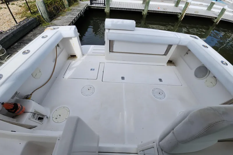 Slide: The Image of 2000 Tiara Yachts 3100 Open boat deck, featuring spacious seating and storage compartments. - 13