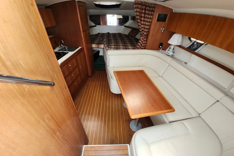 Slide: The Image of Interior of 2000 Tiara Yachts 3100 Open with wood finishes and cozy seating area. - 18