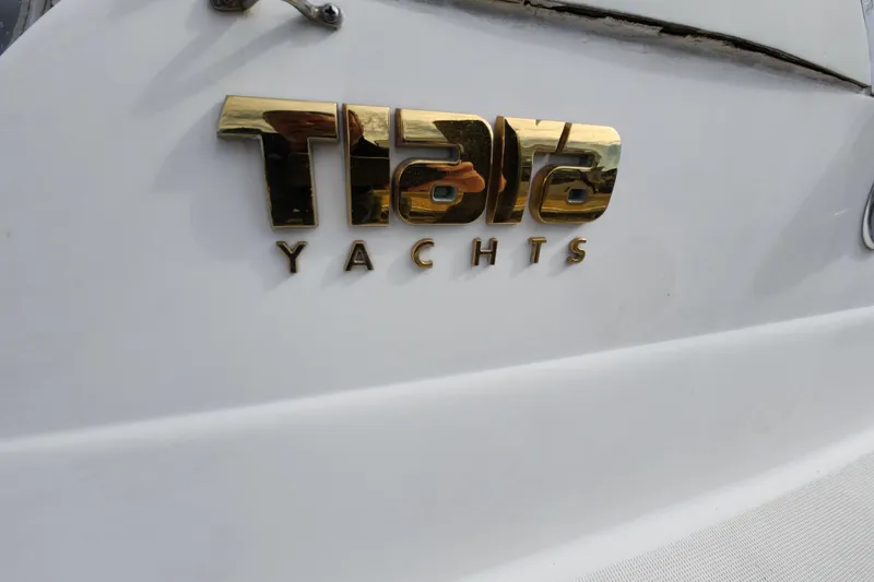 Slide: The Image of Gold Tiara Yachts logo on a 2000 Tiara 3100 Open boat. - 22