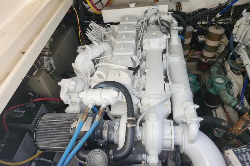 Slide: The Image of Engine compartment of a 2000 Tiara Yachts 3100 Open, showcasing a clean, well-maintained engine. - 26