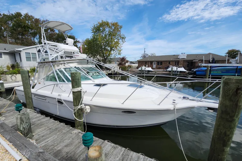 Slide: The Image of 2000 Tiara Yachts 3100 Open docked in calm waters. - 7