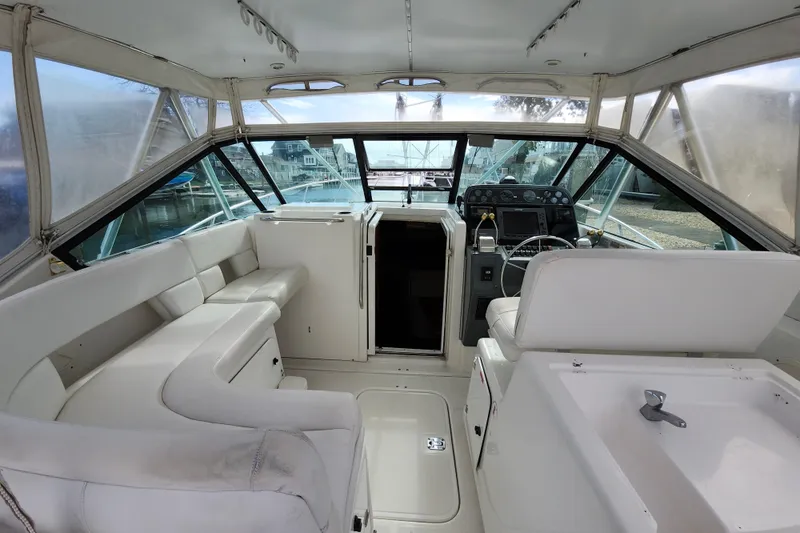 Slide: The Image of Interior of a 2000 Tiara Yachts 3100 Open, featuring helm and seating area. - 9