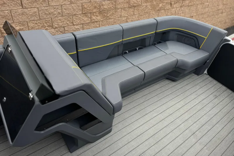 Slide: The Image of Luxurious seating on 2025 Manitou EXPLORE 24 boat, featuring sleek gray upholstery and modern design. - 11
