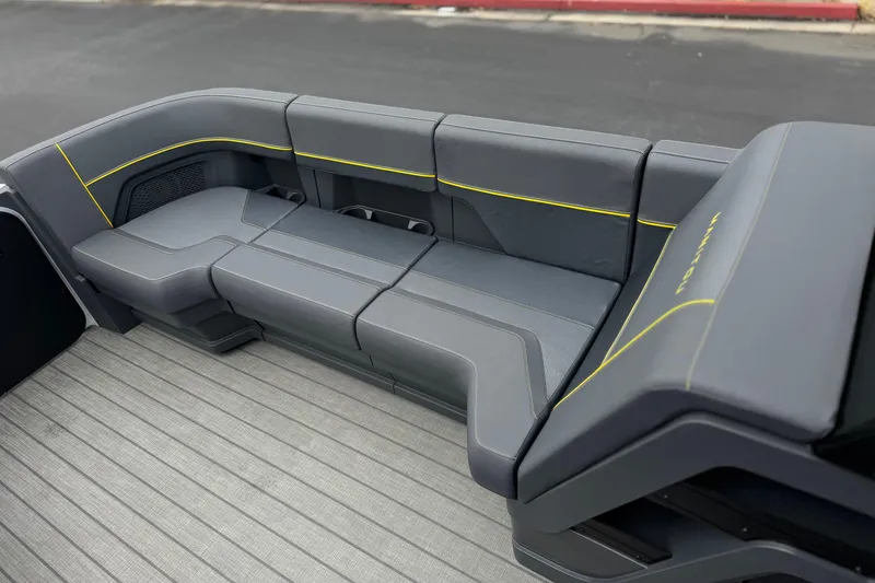 Slide: The Image of Luxurious seating on 2025 Manitou EXPLORE 24 boat, featuring sleek gray upholstery with yellow accents. - 12